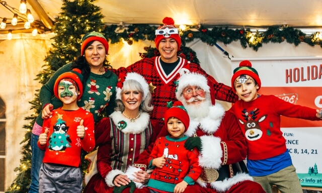 Christmas time photo with sweaters and santa