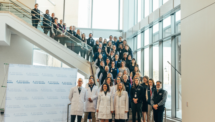 New England Cancer Specialists staff standing on stairway for official opening of Rock Row Health Campus